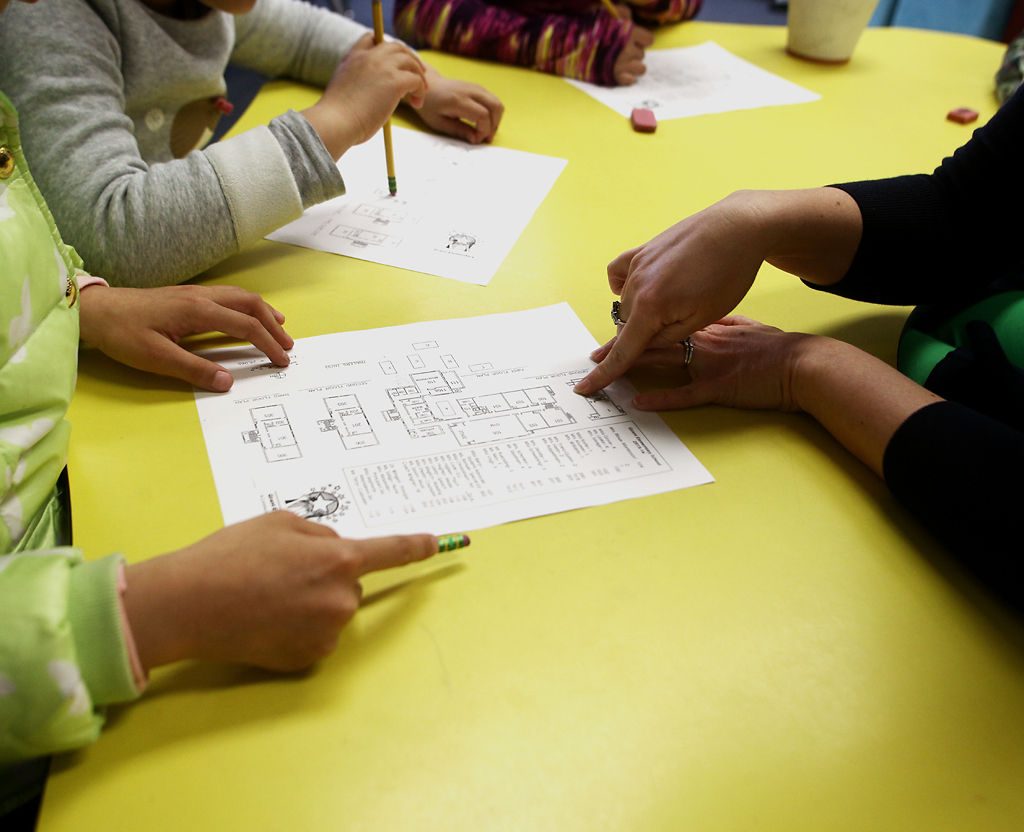 Katie Cook helps students with an assignment